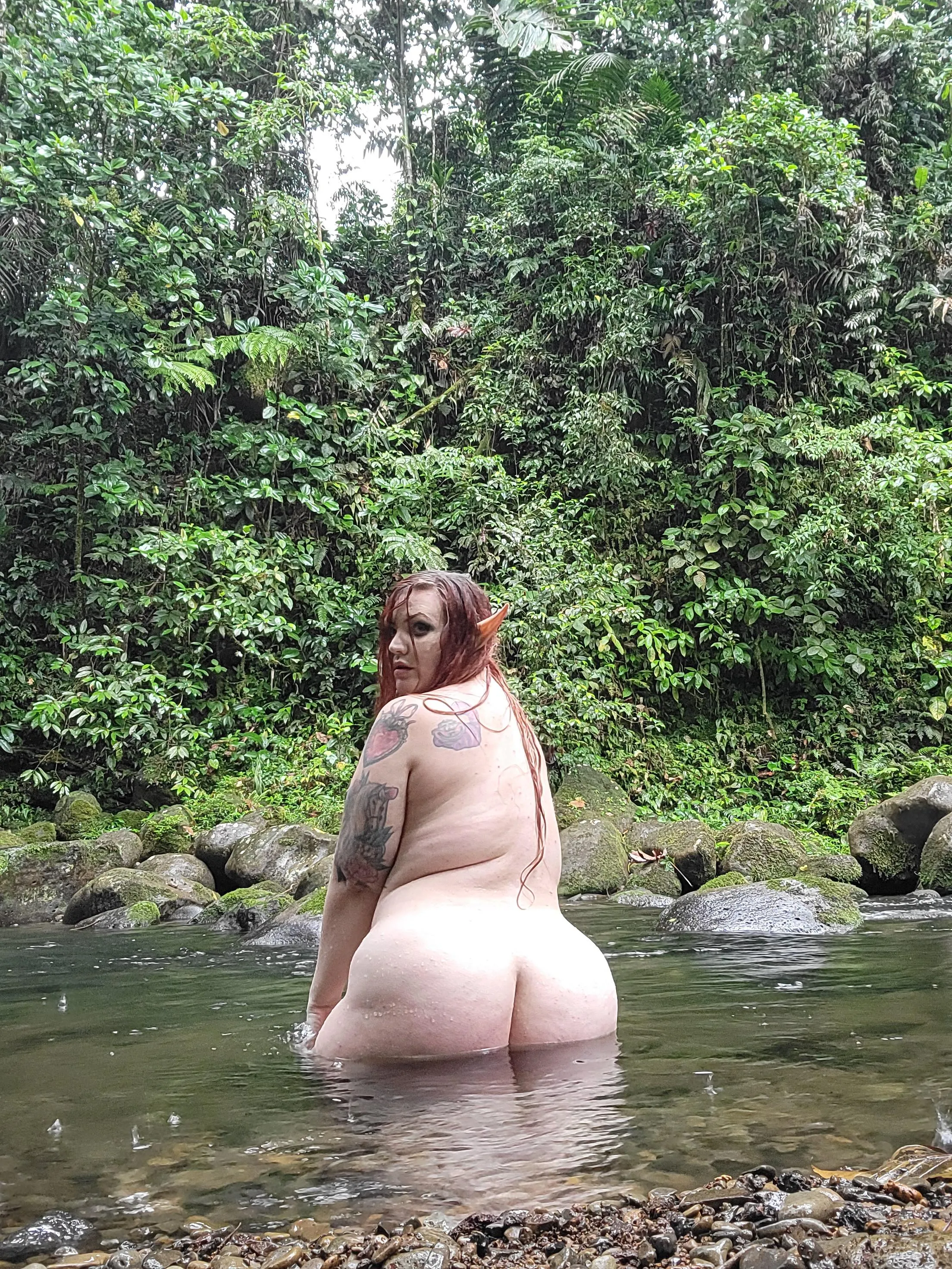 You stumble upon a curvy elf babe playing in the rainy river...